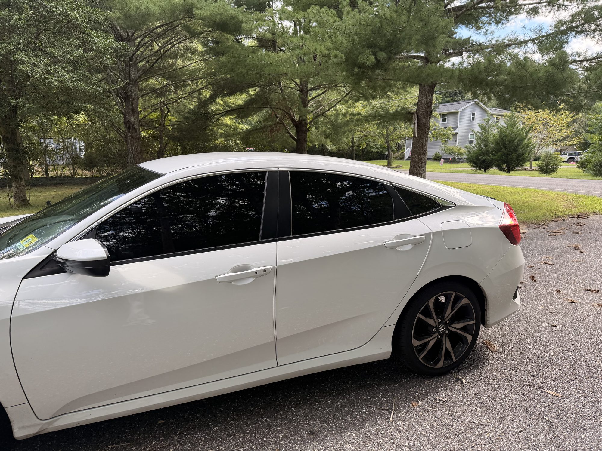 Honda Civic sedan with full ceramic window tint, side profile