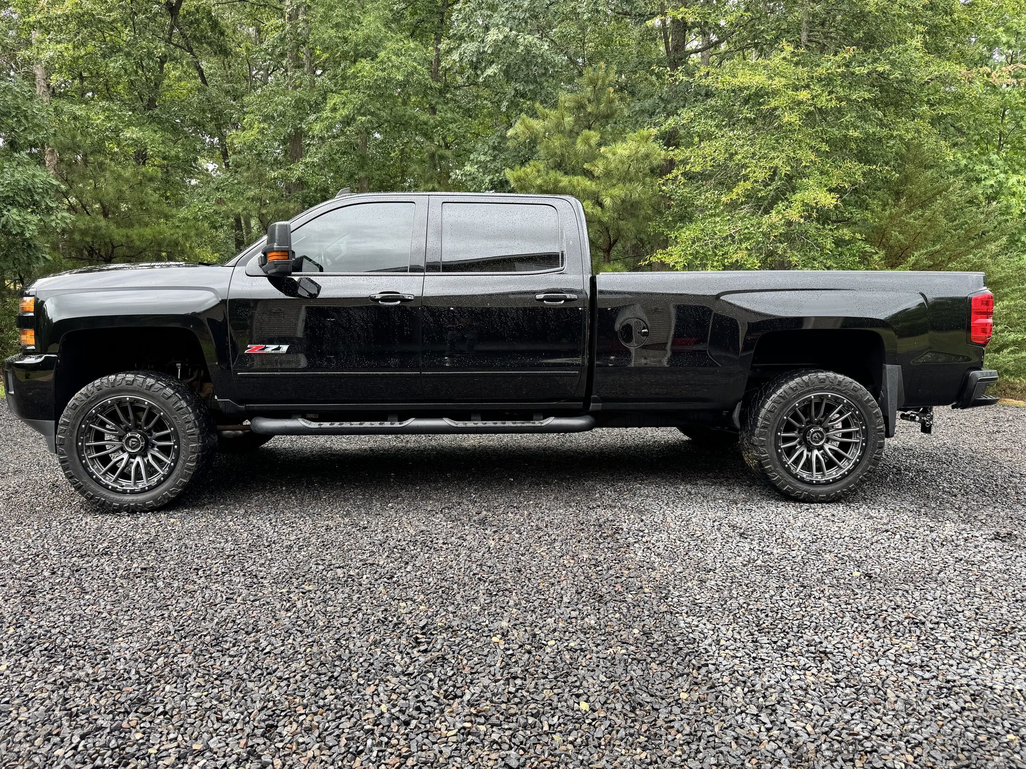 Lifted Chevrolet Silverado 2500 with full ceramic window tint, side profile