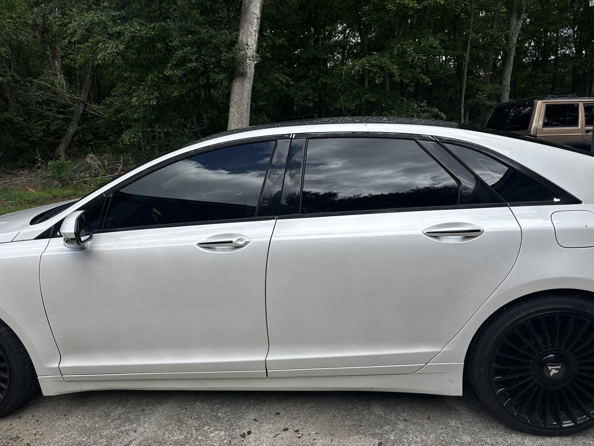 Sedan with full ceramic window tint, side profile